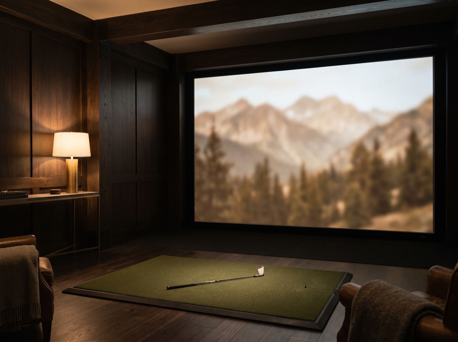 An indoor golf simulator bay in the lodge rec room, screen glowing softly at the far end