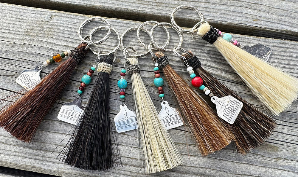 Hand-braided horsehair key chain with a tassel on a steel ring