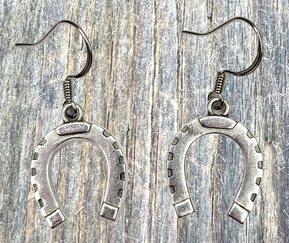 Horsehair earrings shaped around small silver horseshoe charms