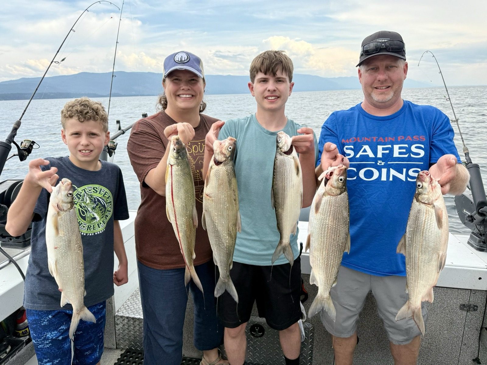 Owner Steve and his family on Flathead Lake, Steve in a Mountain Pass Safes and Coins shirt with the day's catch.