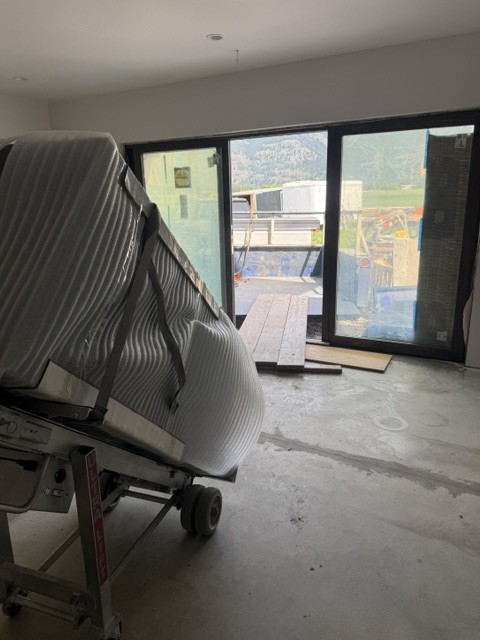 Ultra Lift holding a foam-wrapped safe inside an unfinished room.