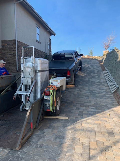 Safe on a drop-deck trailer with a powered stair climber and pickup.