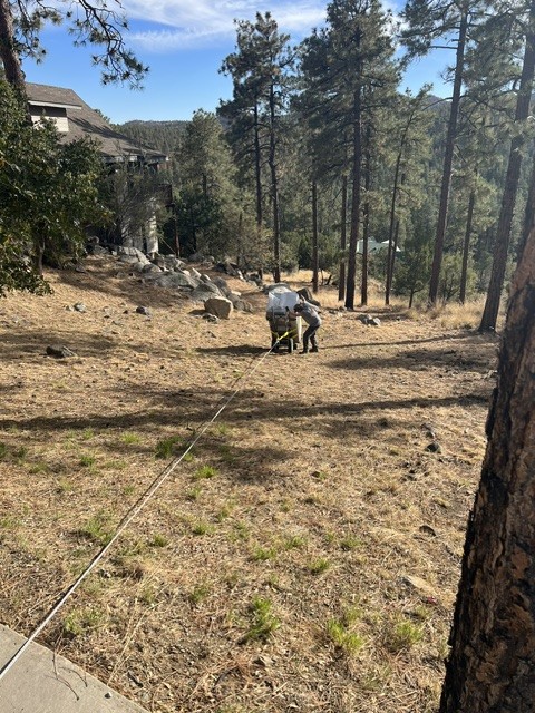 Safe on a dolly walked down a grassy slope with a control line.